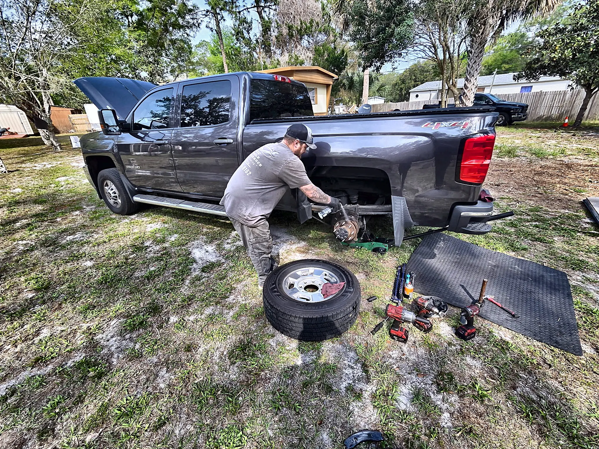 Mobile tire technician mounting a tire on a vehicle in an Ocala driveway